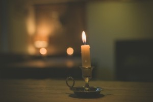 42883379 - a lit candle on a table in a dining room