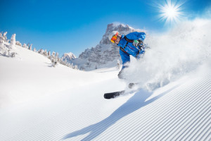 46807718 - skier skiing downhill during sunny day in high mountains